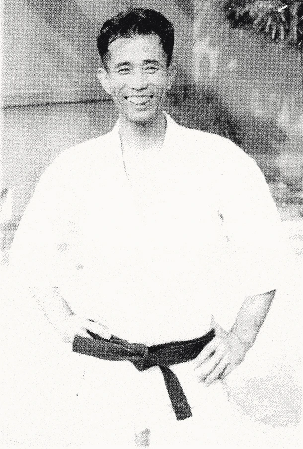 Young Master Shigeru Egami smiling in dogi with black belt