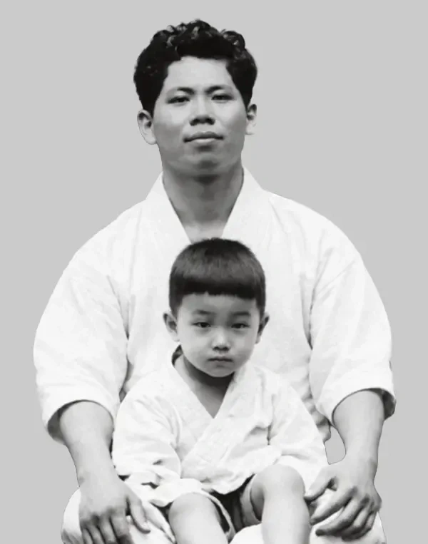 Rare uncropped portrait of Yoshitaka Funakoshi holding a child in dogi